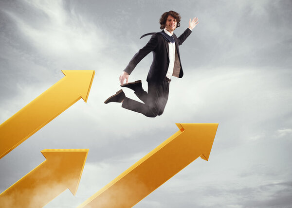 Businessman jumps on big arrows