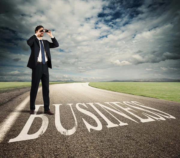 Businessman looks at the economic future — Stock Photo, Image