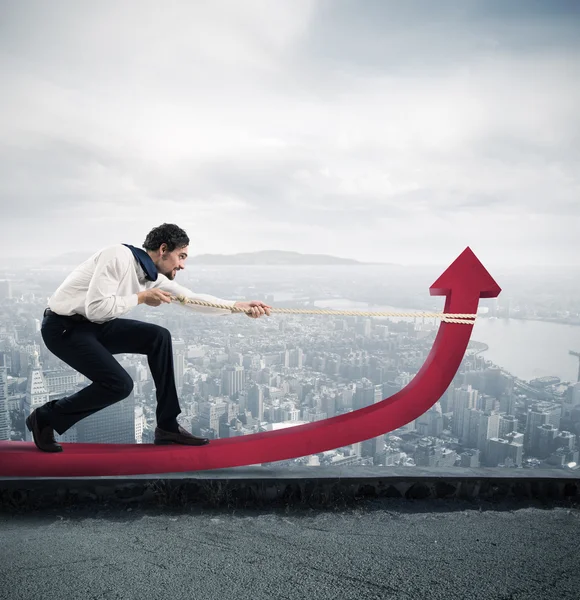 Businessman with much effort lifts statistics arrow — Stock Photo, Image