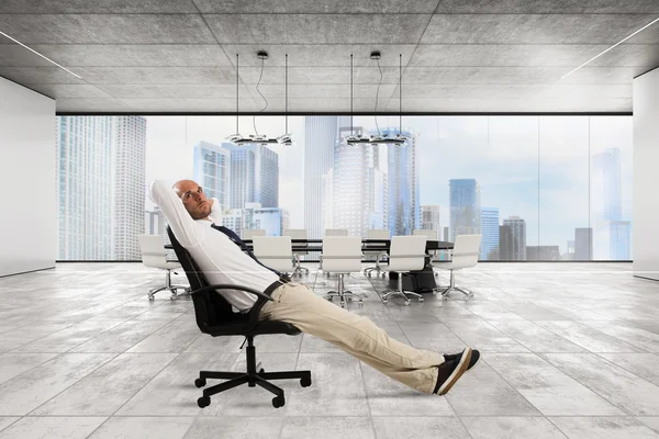 Successful businessman sitting in a chair — Stock Photo, Image