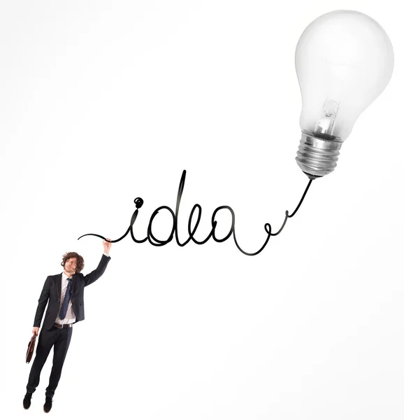 Man hanging on the written idea — Stock Photo, Image