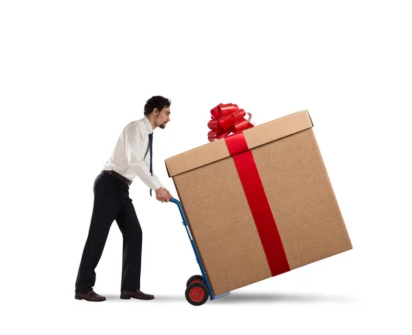 Businessman pushes heavy great gift — Stock Photo, Image