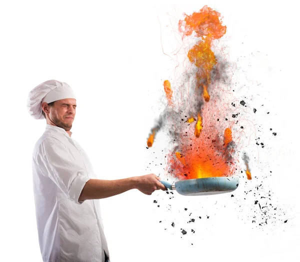 Bumbling chef holds a pan — Stock Photo, Image