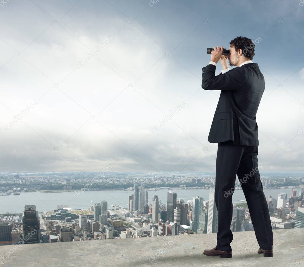 Businessman looks at the city 