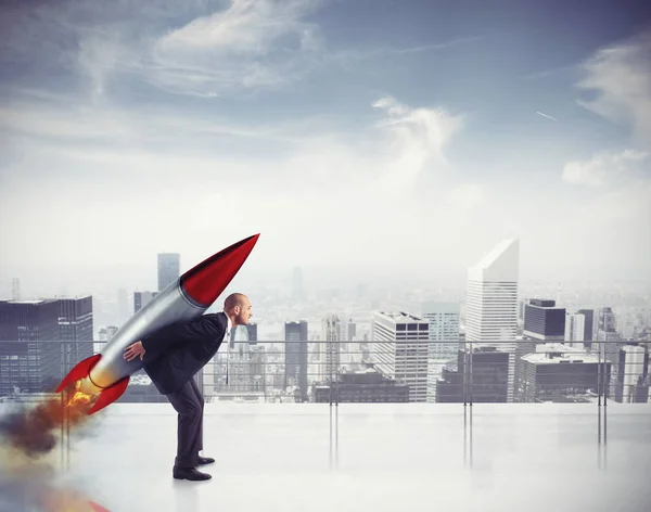 Determined businessman flying with a rocket — Stock Photo, Image