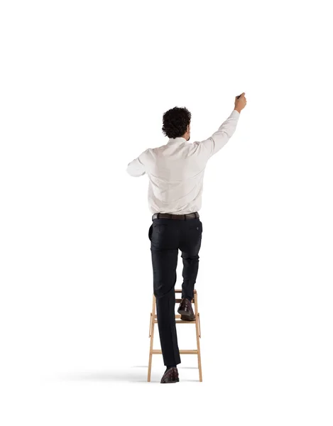 Man on a ladder draws — Stock Photo, Image