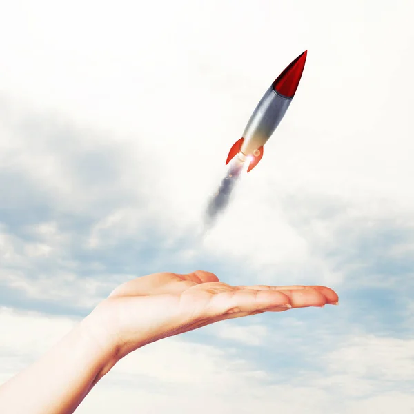 Businesswoman holding a small rocket — Stock Photo, Image