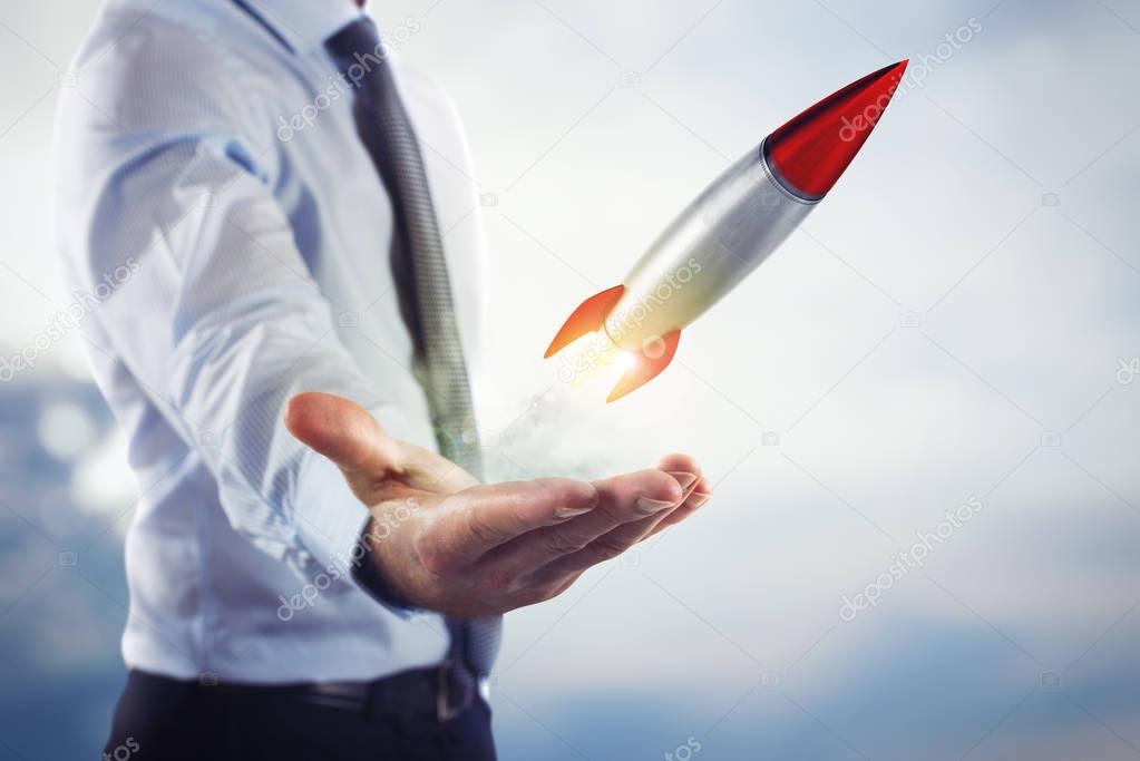 Businessman holding a small rocket
