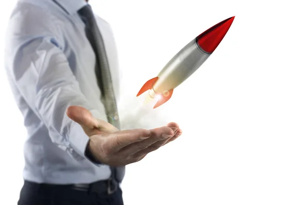 Businessman holding a small rocket. — Stock Photo, Image