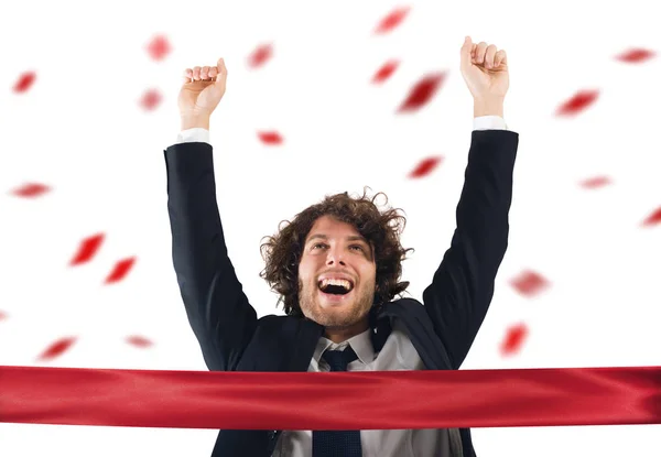 Businessman comes to the red ribbon of victory — Stock Photo, Image