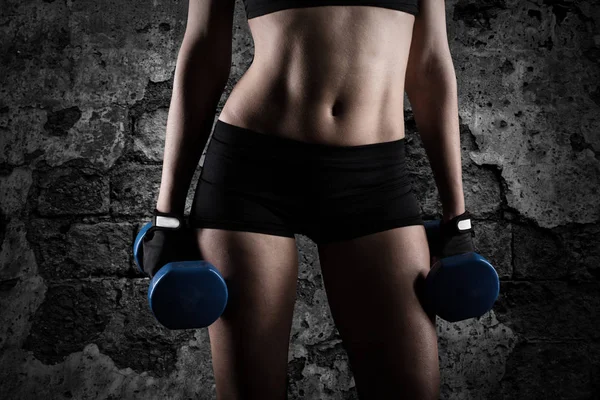 Woman training biceps with dumbbells — Stock Photo, Image