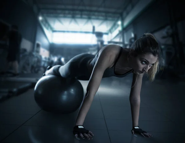 Kaslı kadın fitness topu ile eğitim — Stok fotoğraf