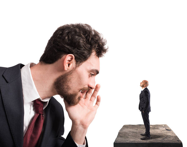 Businessman speaks  to a small man.