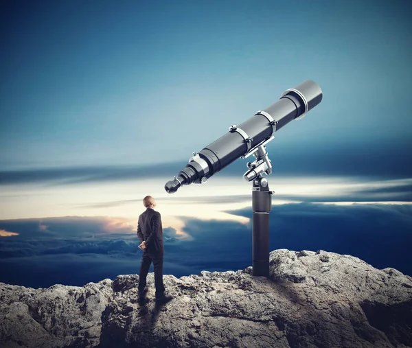 Businessman looks in telescope — Stock Photo, Image