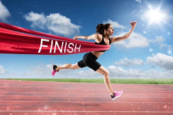 Athletic woman goes beyond the ribbon — Stock Photo, Image