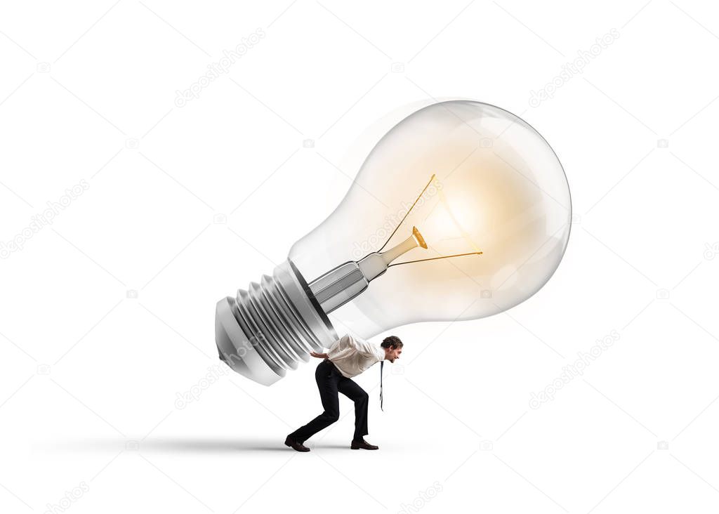 Businessman holds a big light bulb. 