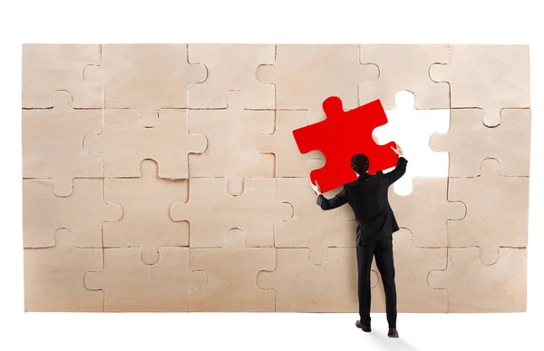 Businessman completing  a puzzle — Stock Photo, Image