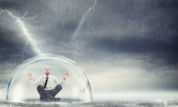 Empresário sentado dentro de uma esfera — Fotografia de Stock