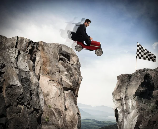 Businessman jumps between two mountains — Stock Photo, Image