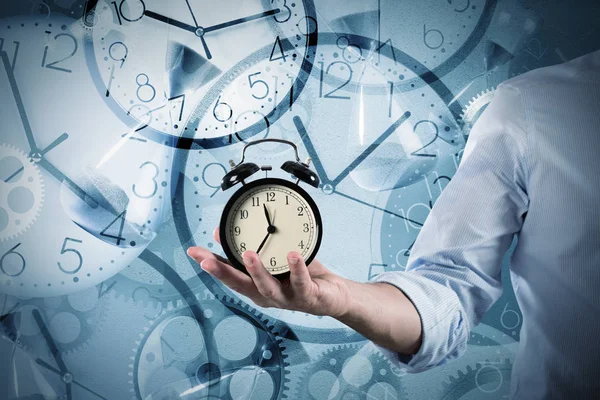 Businessman holds an alarm clock — Stock Photo, Image