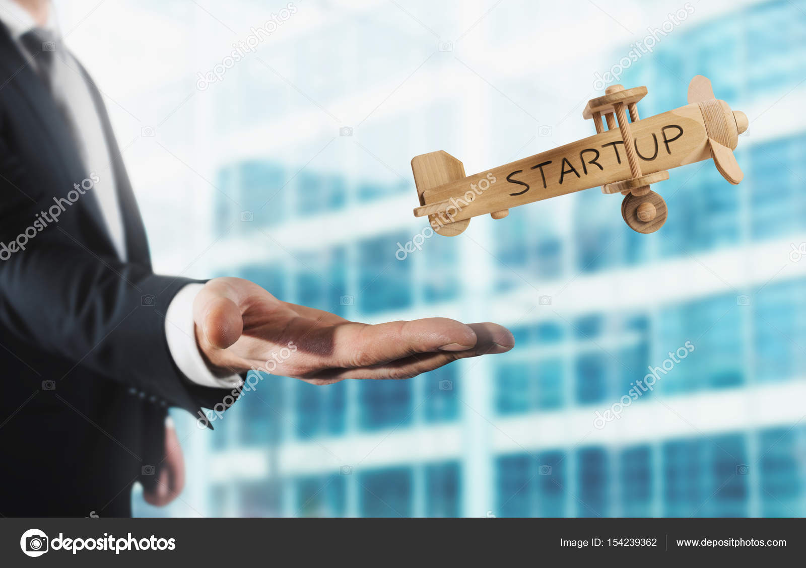 Businessman Holding A Small Wooden Aircraft Stock Photo By C Alphaspirit 154239362