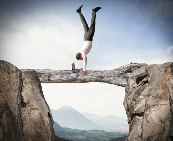 Businessman balancing on a trunk — Stock Photo, Image