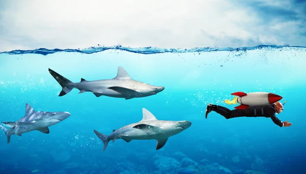 Hombre de negocios que escapa de los tiburones — Foto de Stock