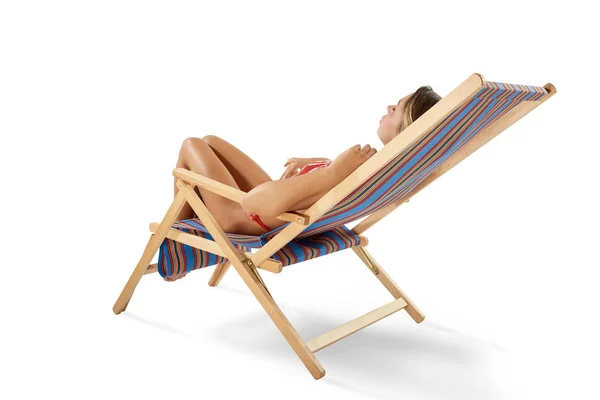 Girl tanning  on a deck chair — Stock Photo, Image