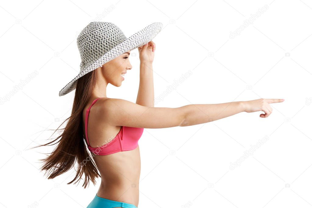 Girl in bikini swimsuit pointing  