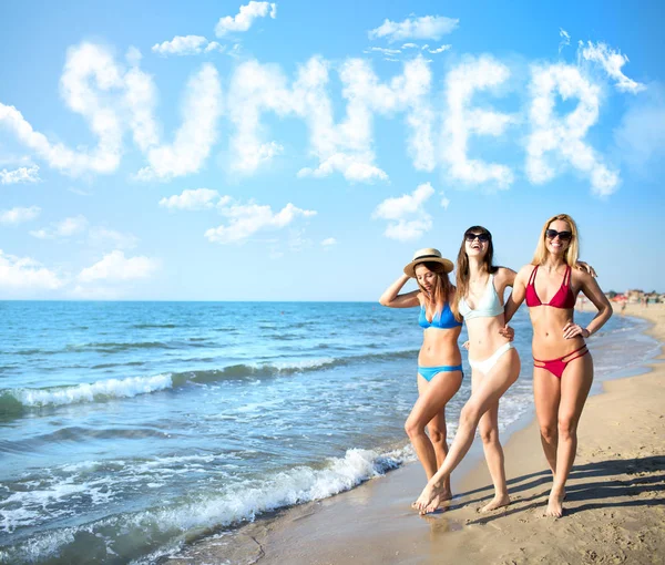 Group of happy friends having fun at ocean beach with summer word made of clouds — Stock Photo, Image