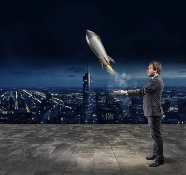 Businessman throwing  a rocket — Stock Photo, Image