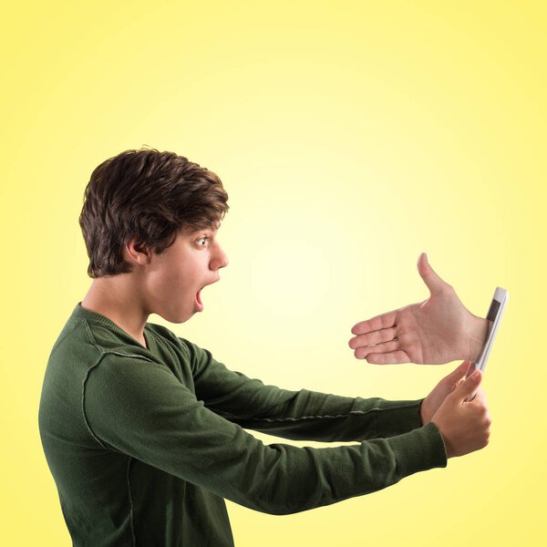 Hand comes out of the tablet t