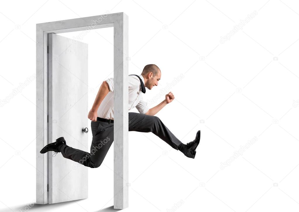 Businessman crossing  a door. 