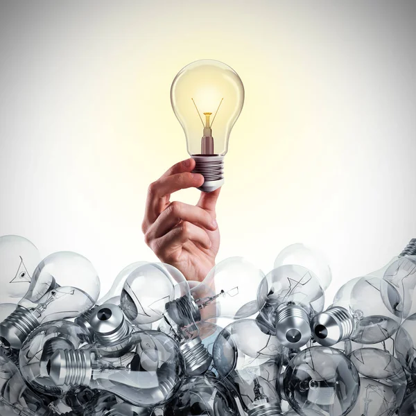 Bright bulb lit between unlit bulbs. — Stock Photo, Image