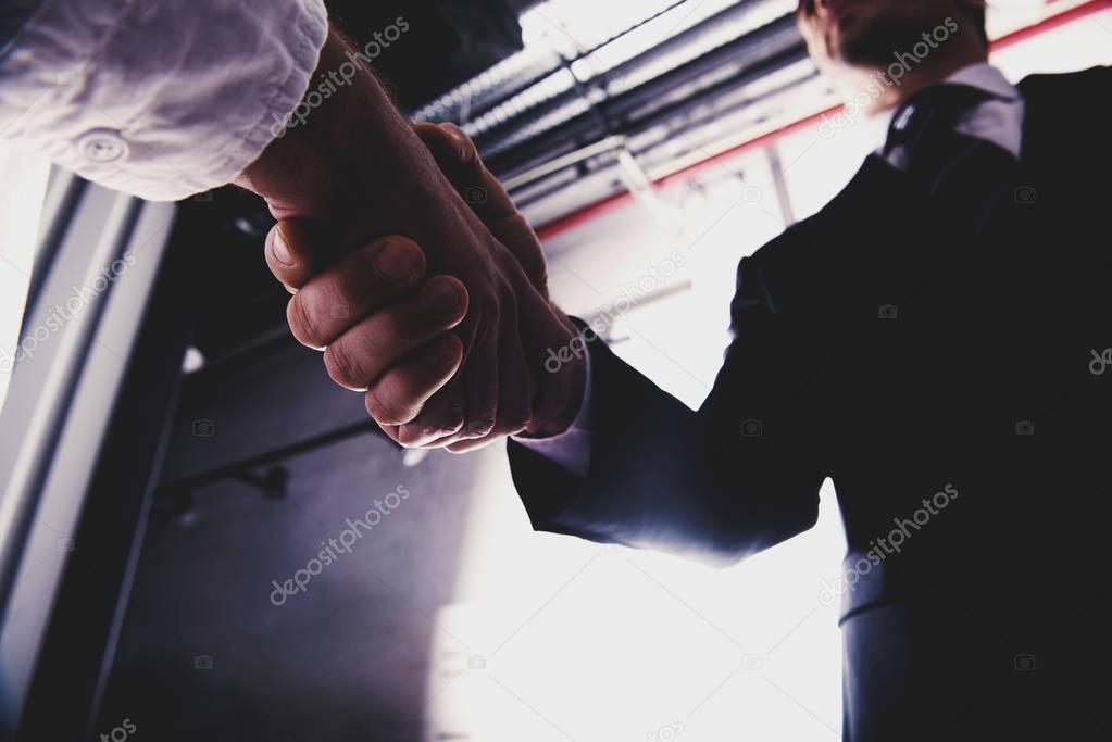 Handshaking business people in the office. 