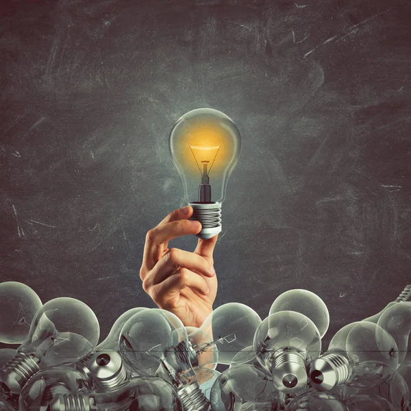 Bright bulb lit between unlit bulbs. — Stock Photo, Image