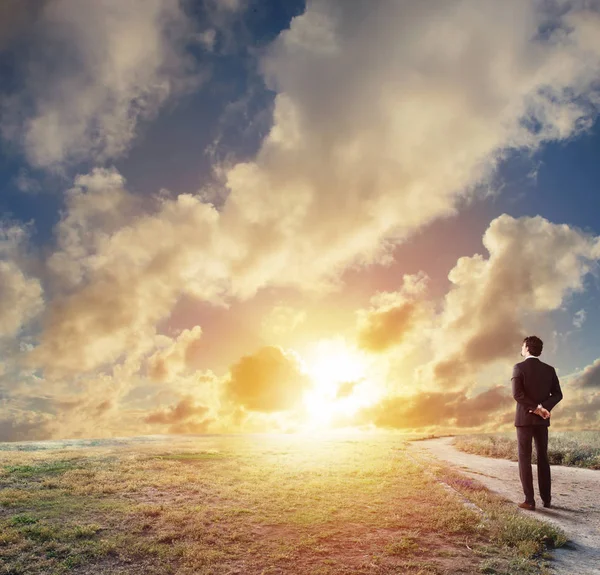 Businessman looks far during sunrise. — Stock Photo, Image