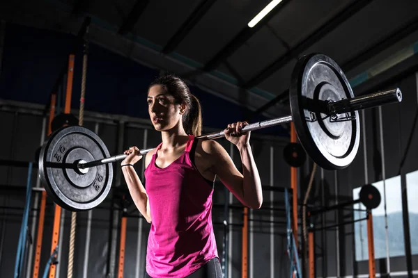 Спортсменка працює в спортзалі з барбелом — стокове фото