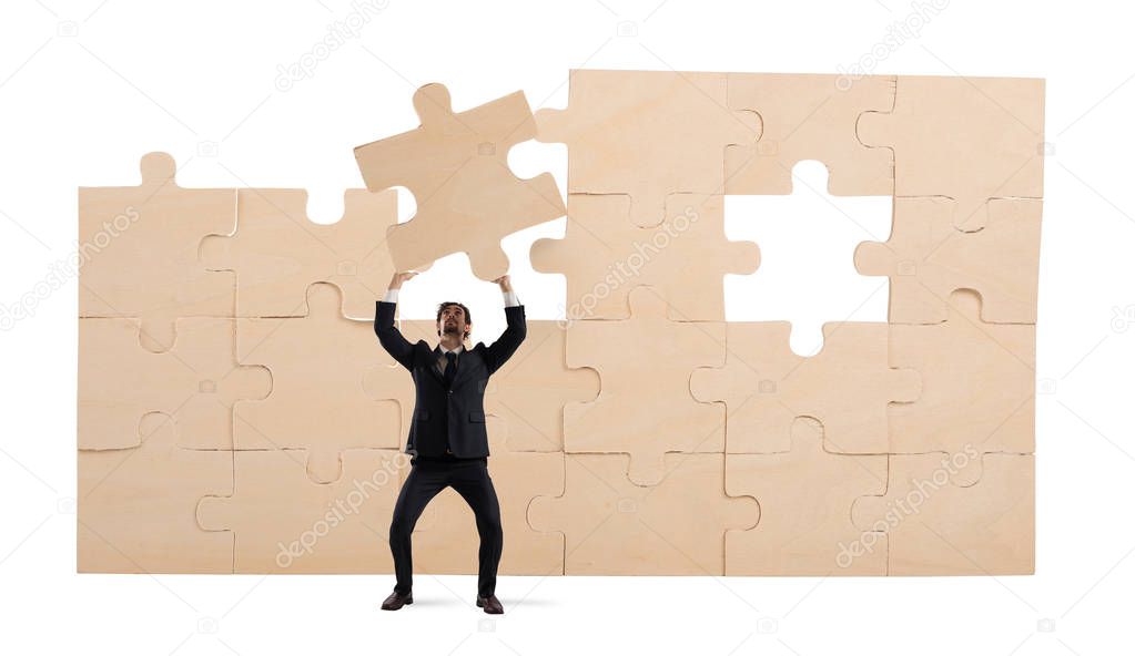 Businessman with a piece of puzzle. Build the business concept