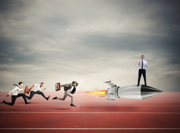 Winner businessman over a fast rocket. Concept of business competition — Stock Photo, Image