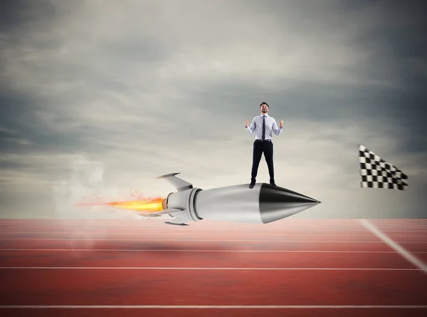 Winner businessman over a fast rocket. Concept of business competition — Stock Photo, Image