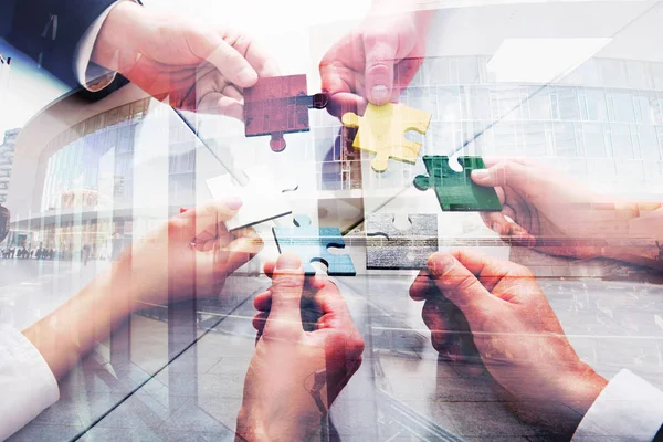Teamwork of partners. Concept of integration and startup with puzzle pieces. double exposure — Stock Photo, Image