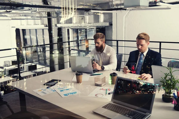 Business people that work together in office at the night. Concept of teamwork and partnership. double exposure