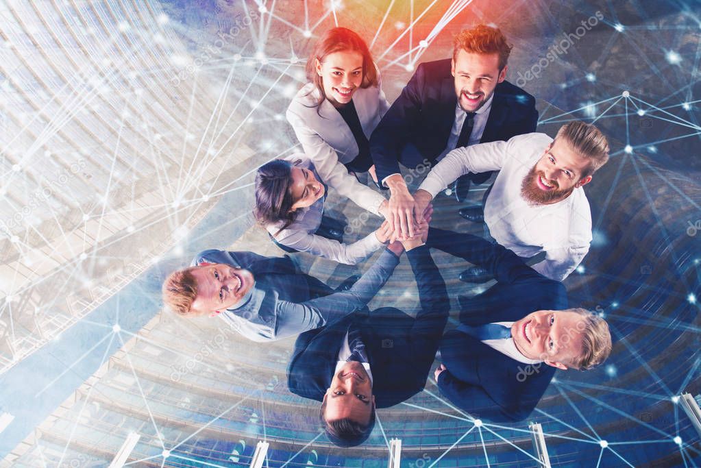 Business people putting their hands together with internet network effects. Concept of integration, teamwork and partnership. double exposure