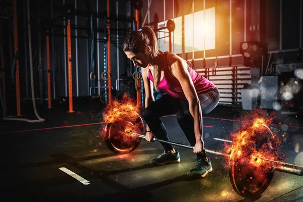 Atletica ragazza si allena in palestra con un ardente bilanciere — Foto Stock