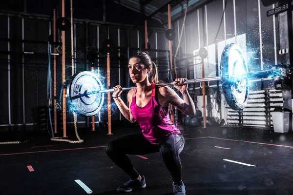 Αθλητικό κορίτσι λειτουργεί έξω στο γυμναστήριο με ένα barbell με γαλάζια ενέργεια επιδράσεις — Φωτογραφία Αρχείου