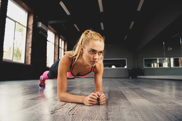 Sarışın kız bir spor salonunda egzersiz — Stok fotoğraf
