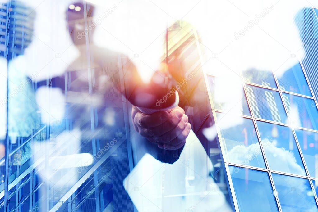 Handshaking business person in office. concept of teamwork and partnership. Double exposure