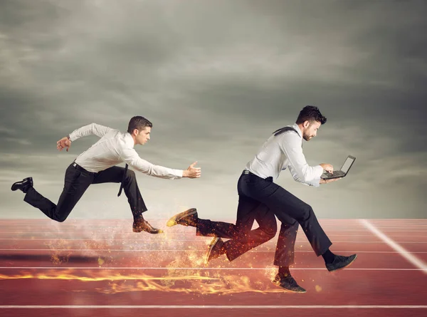 Businessman with four legs runs with too many tasks on laptop. Concept of competition and success — Stock Photo, Image