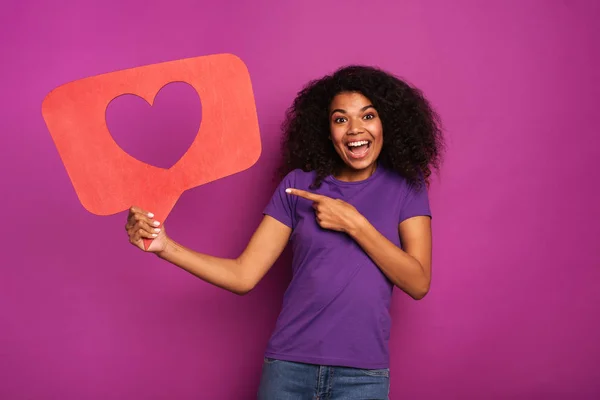 Woman is happy because receives hearts on social network — Stock Photo, Image